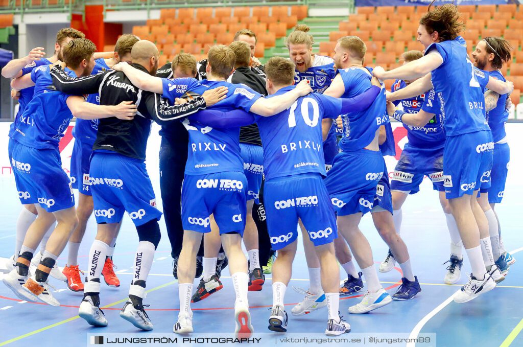 A group of handball players celebrating a victory