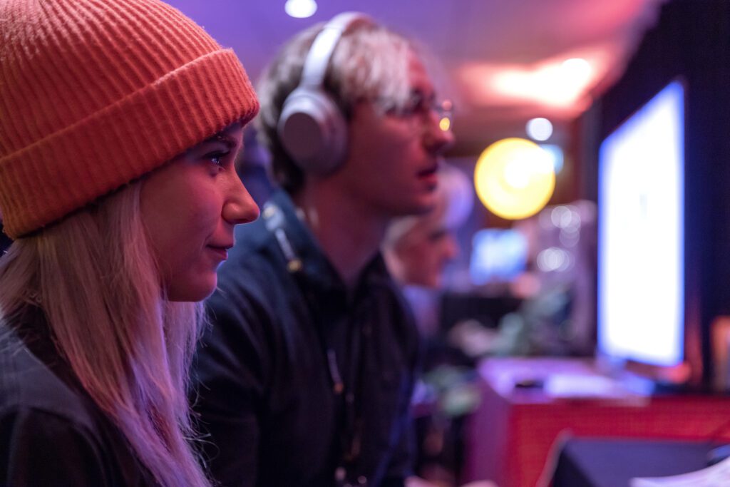 A woman and a man are sitting and looking at a computer screen. Gaming industry Skövde